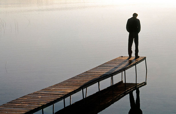 Man Pondering by a Lake